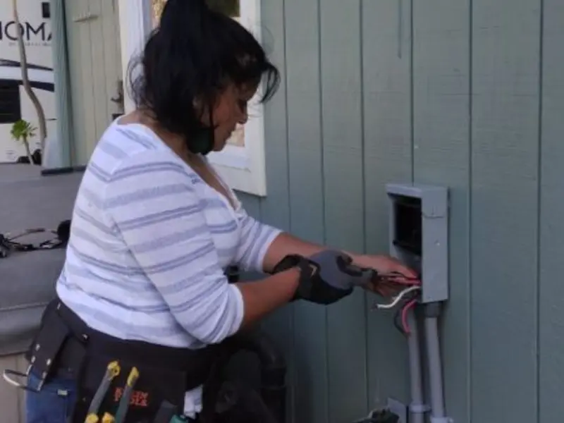 Licensed electrician wiring an exterior subpanel in Forest